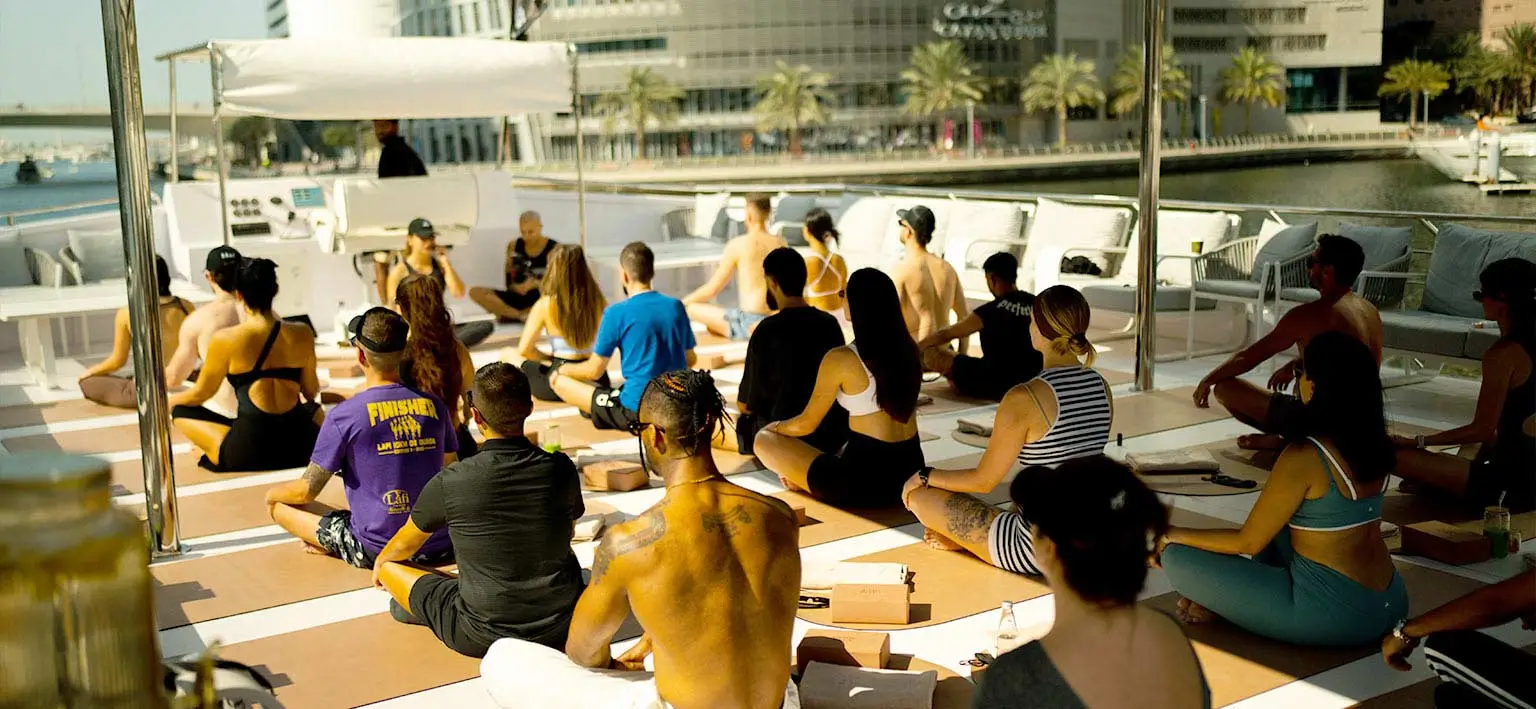 wellness boat party Dubai yacht sunset yoga session
